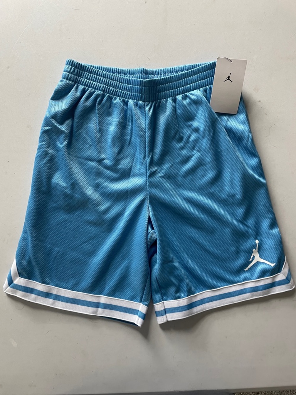 NEW! LIGHT BLUE W/ WHITE TRIM JORDAN BASKETBALL SHORTS. SIZE LARGE (12-13) BOYS.